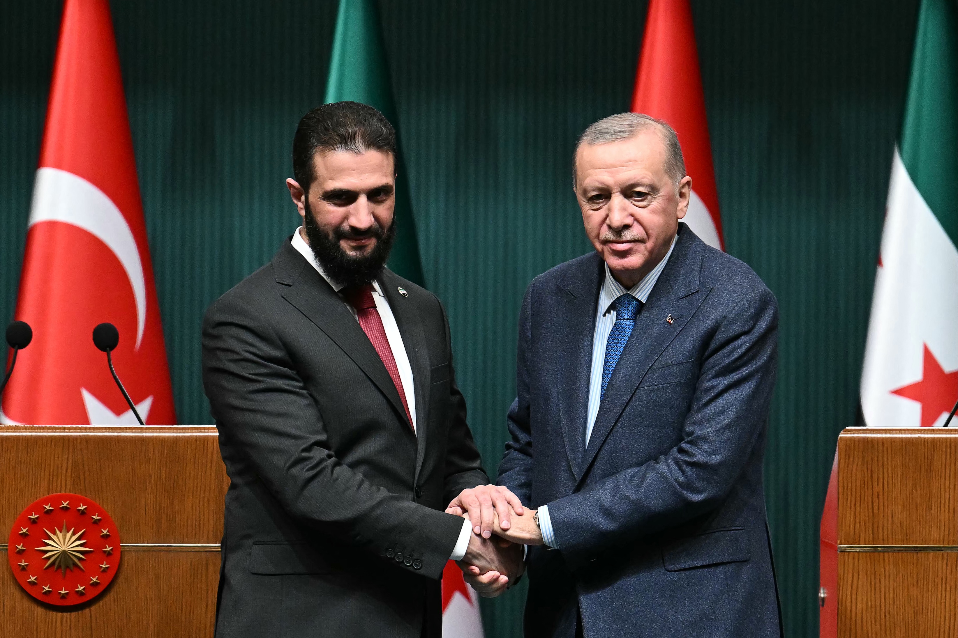 Turkish President Recep Tayyip Erdogan and Syria's interim president Ahmed al-Sharaa shake hands during a joint press conference in Ankara, Feb. 4, 2025. (AFP)