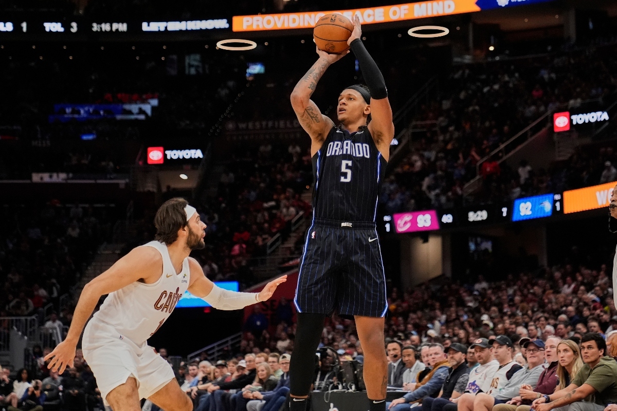 Orlando Magic forward Paolo Banchero (5) shoots over Cleveland Cavaliers guard Max Strus, left, in the second half of an NBA basketball game Sunday, March 16, 2025, in Cleveland. (AP Photo/Sue Ogrocki)