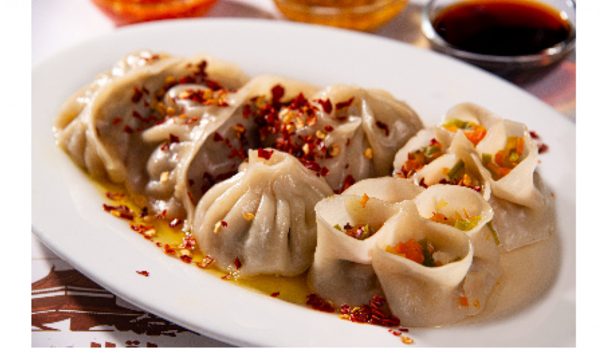 Mixed Dumplings – A delicious combination of chicken, beef, and shrimp dumplings, topped with chili flakes and served with dipping sauces for extra flavor. (Supplied)