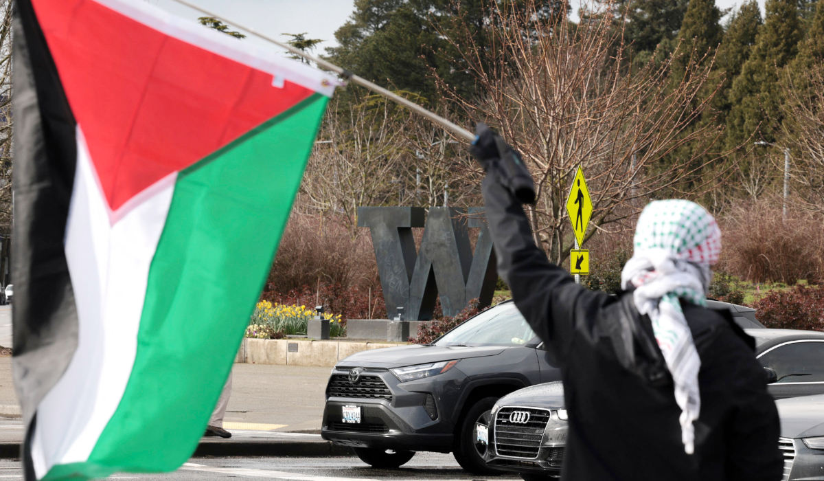 A person holds a Palestinian flag as they protest the arrest of former Columbia University student activist Mahmoud Khalil at the University of Washington campus in Seattle, Washington, on March 15, 2025. (AFP)