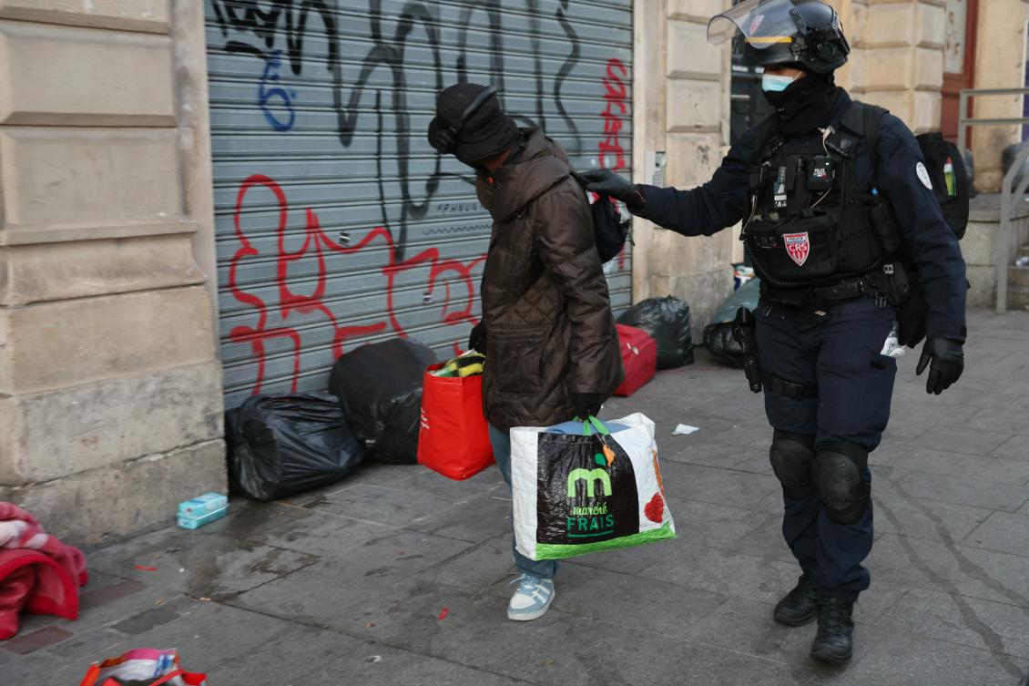 Authorities escort people from the Gaite Lyrique, a Parisian performance hall occupied for three months by 450 young migrants, following a police order to vacate the premises in Paris on March 18, 2025. (AFP)