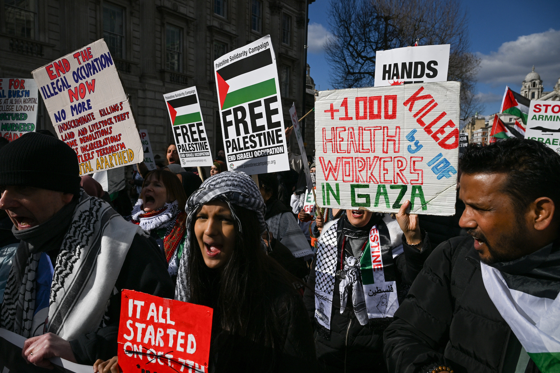 Pro-Palestinian demonstrators hold placards as they gather in opposition to Israel reimposing its blockade of fuel and humanitarian aid to Gaza and U.S. President Donald Trump's plan to "take over" the territory, in London, Britain March 15, 2025. (Reuters)