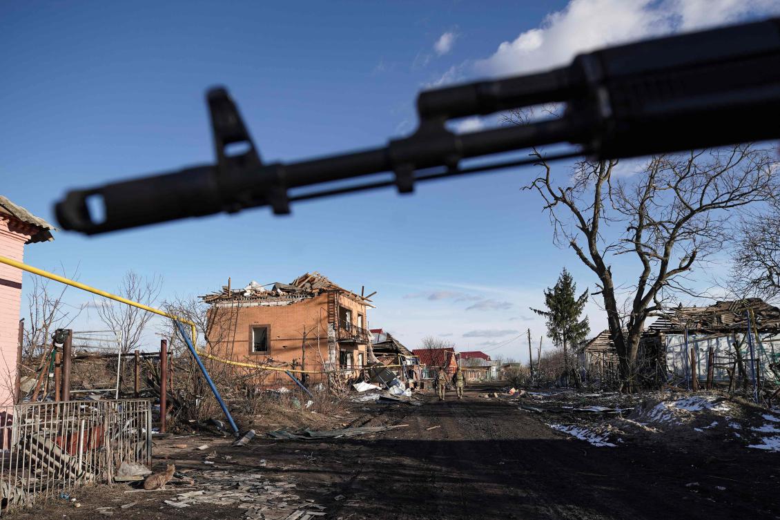 Russian soldiers walk past destroyed houses in the village of Kazachya Loknya, which was previously held by Ukrainian troops and recently retaken by Russia’s armed forces, in the Sudzha district of the Kursk region on Mar. 18, 2025. (AFP)