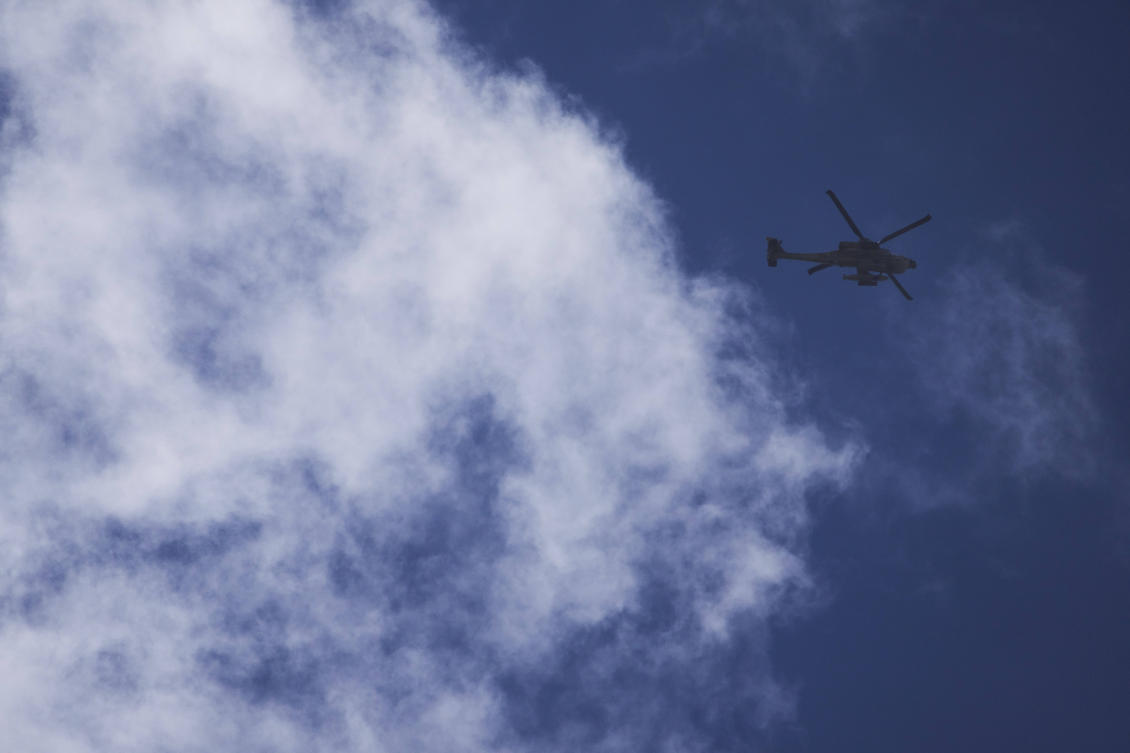 An Israeli Apache flies over the Gaza border as seen from southern Israel, Wednesday, March 19, 2025. (AP)