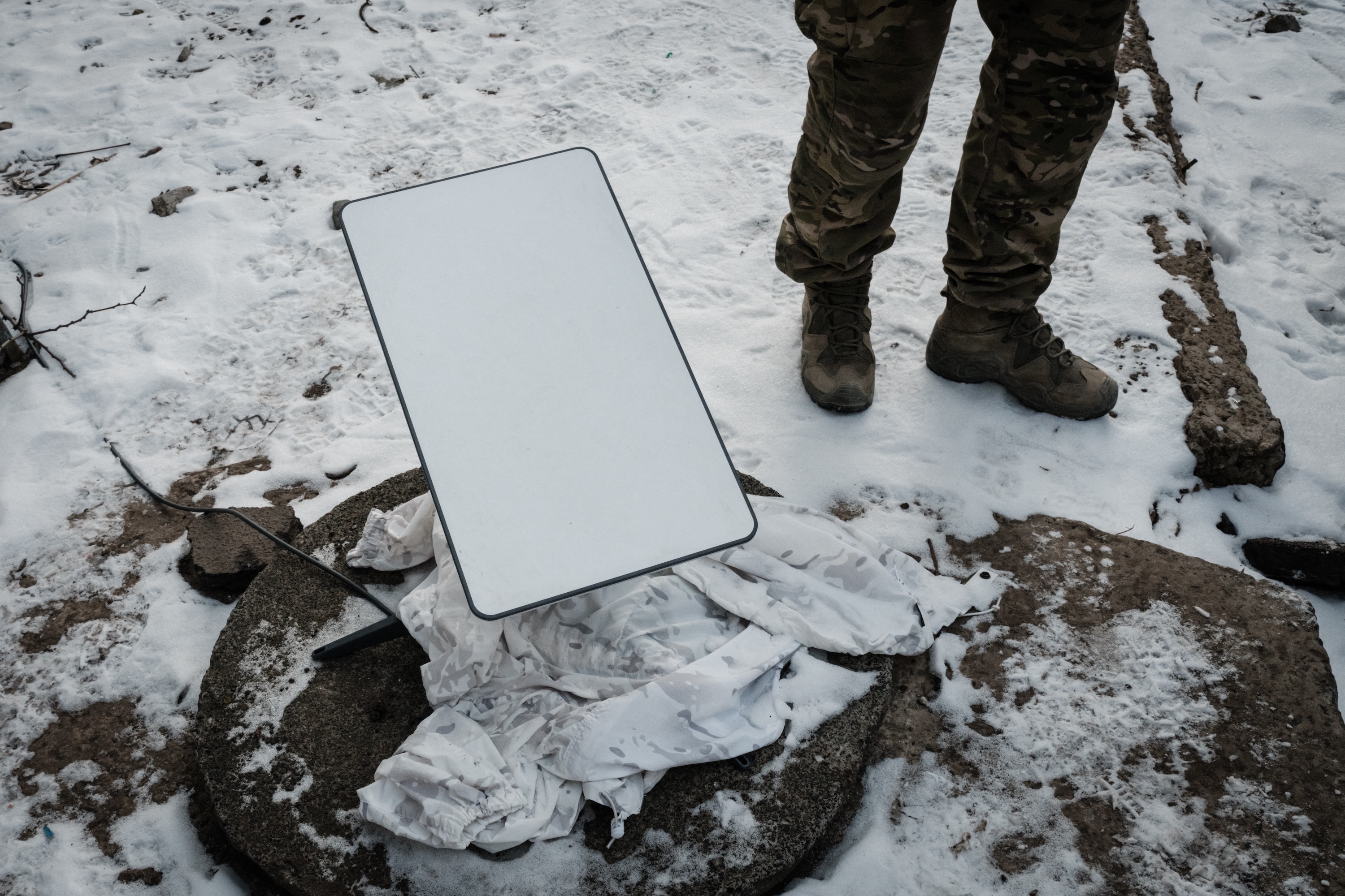 A Ukrainian serviceman stands next to the antenna of the Starlink satellite-based broadband system in Bakhmut amid the Russian invasion of Ukraine, Feb. 9, 2023. (AFP)