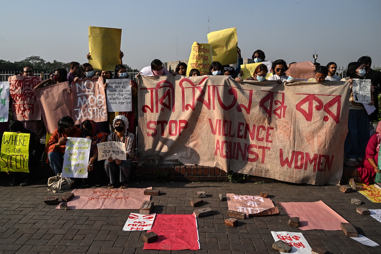 Women activists holding posters take part in a protest in front of Bangladesh's Parliament building in Dhaka on March 7, 2025, condemning violence against women in the country. (AFP)