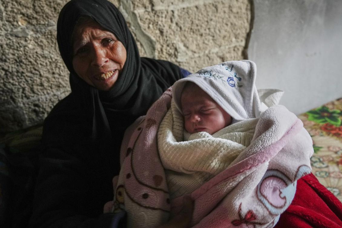 Ella Osama Abu Dagga, 25 days old, is held by her great-aunt Suad Abu Dagga after she was pulled from the rubble earlier following an Israeli army airstrike that killed her parents and brother in Khan Younis, southern Gaza Strip, Mar. 20, 2025. (AP)