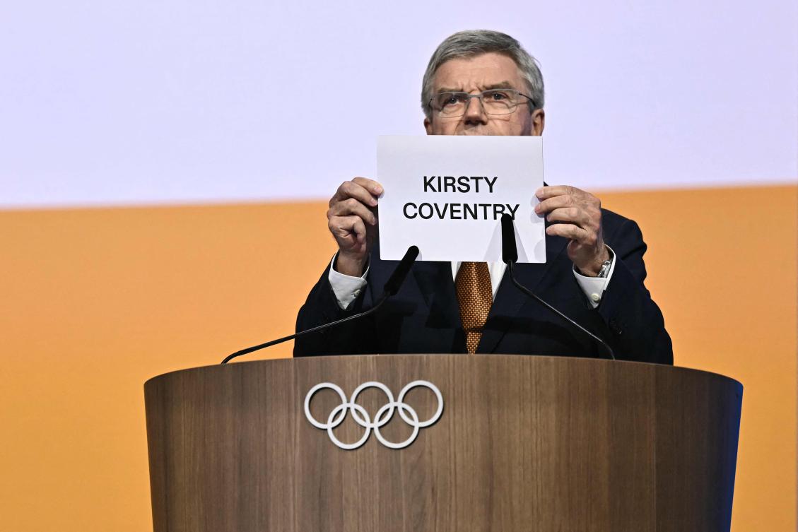 IOC outgoing president Thomas Bach shows the name of Kirsty Coventry during the 144th IOC Session on the day of the election of the next President of the International Olympic Committee, in Costa Navarino, Greece on Mar. 20, 2025. (AFP)