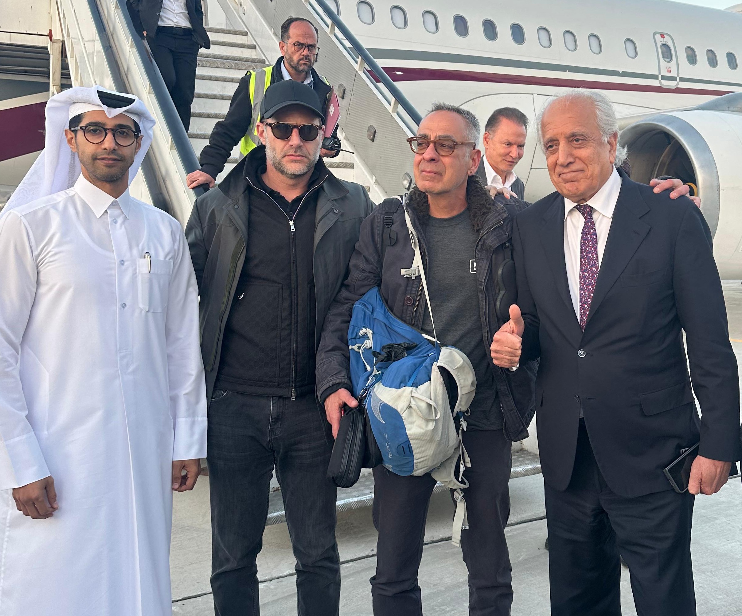 US citizen George Glezmann (C) posing for a picture with US official Adam Boehler (C-L), former US envoy to Afghanistan Zalmay Khalilzad (C-R), and Qatari diplomats in Kabul, Mar. 20, 2025. (AFP)