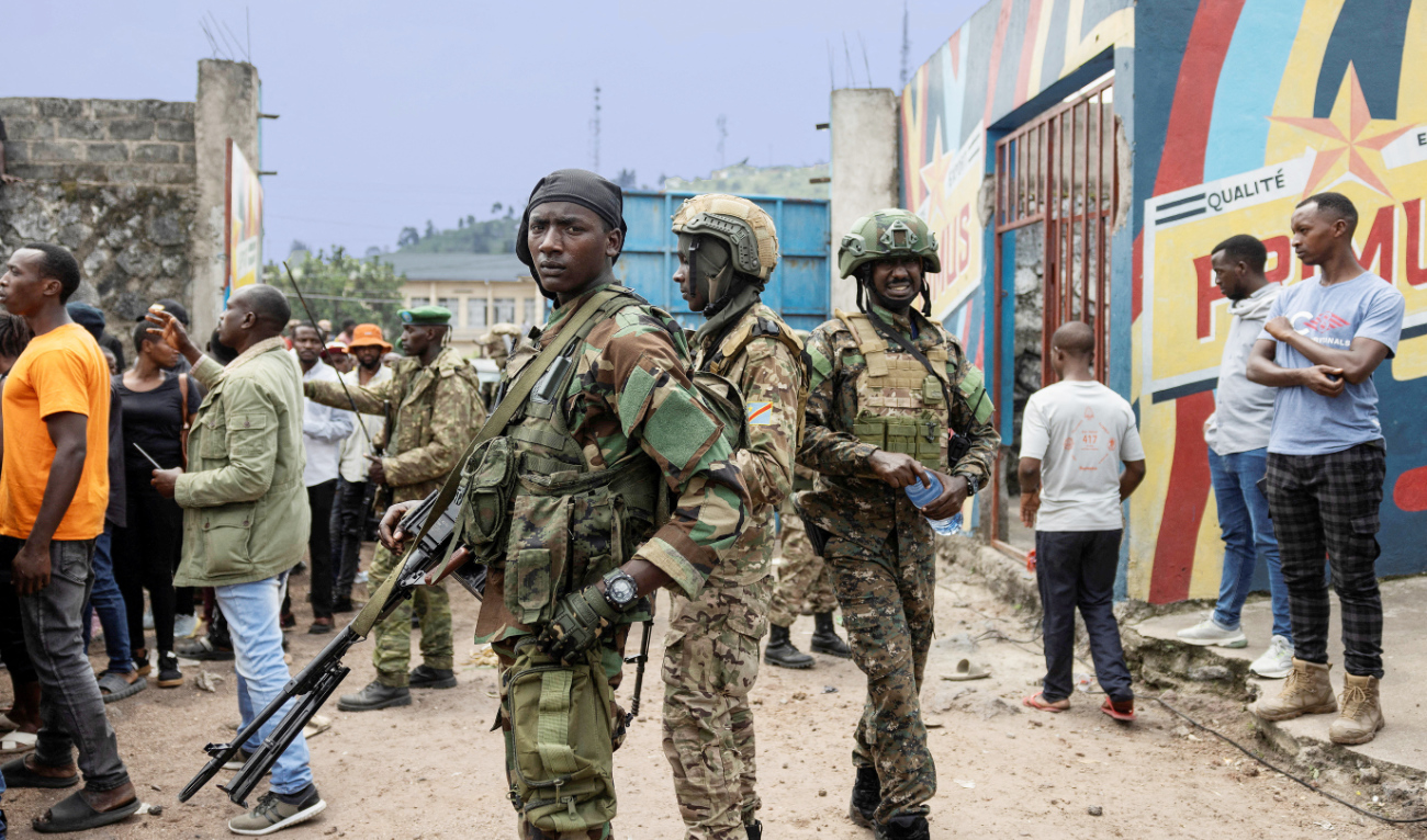M23 rebels stand guard during a meeting in Goma. (File/Reuters)