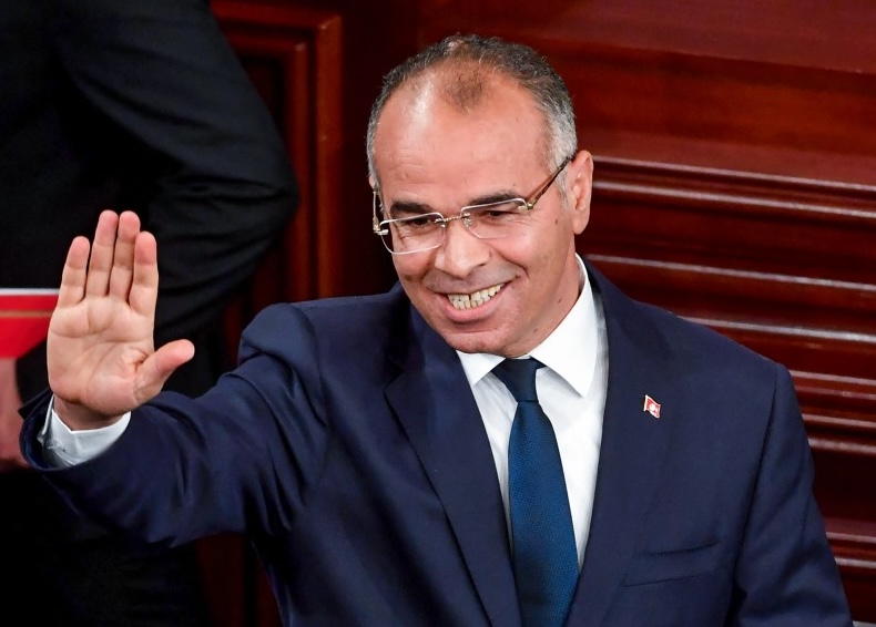 Tunisia's Prime Minister Kamel Madouri waves as he arrives to attend President Kais Saied's swearing-in ceremony before the National Assembly in Tunis on October 21, 2024 (AFP)