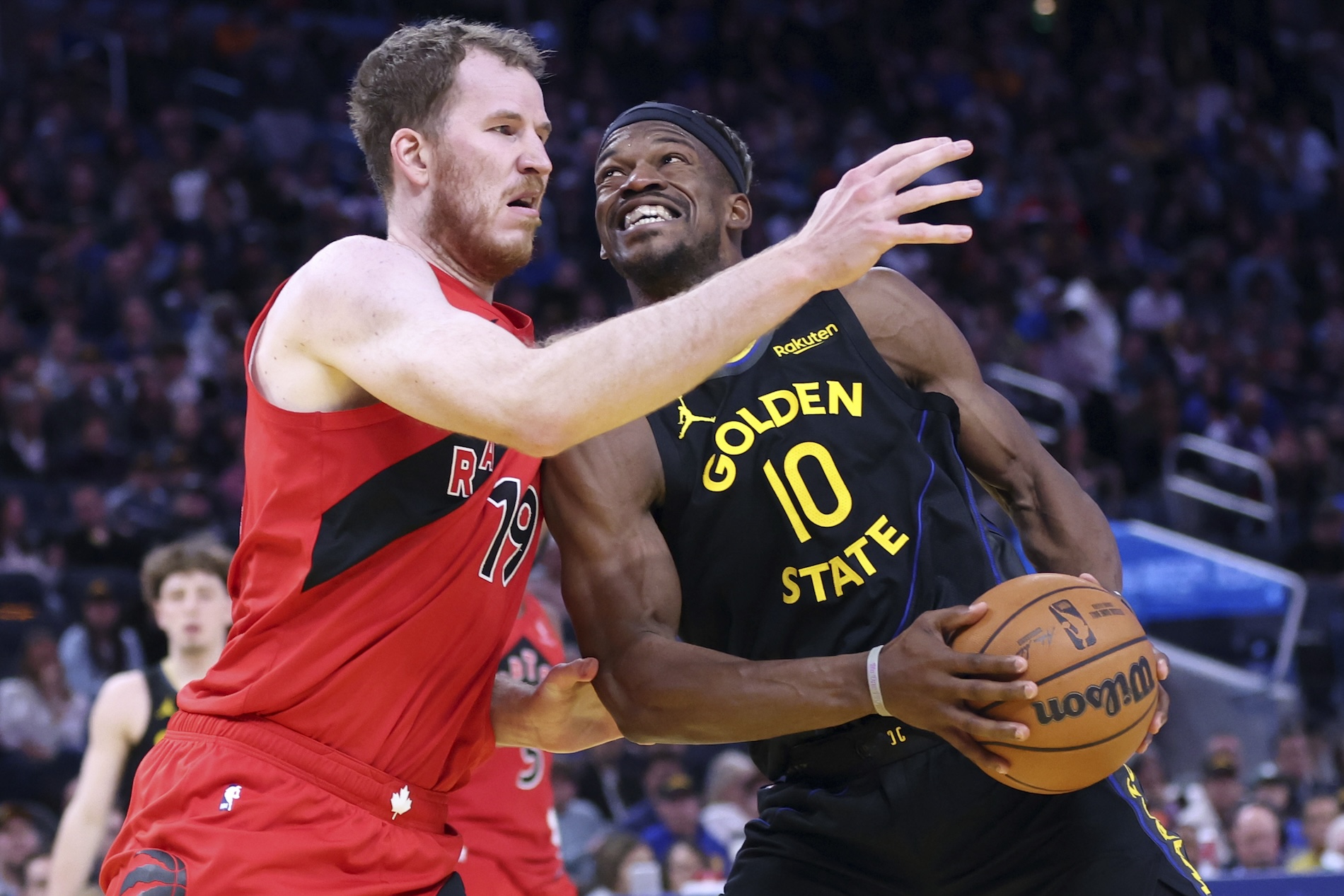 Golden State Warriors’ Jimmy Butler III drives against Toronto Raptorss’ Jakob Poeltl in 4th quarter during Dubs' 117-114 win in NBA game at Chase Center in San Francisco on Thursday. (AP)