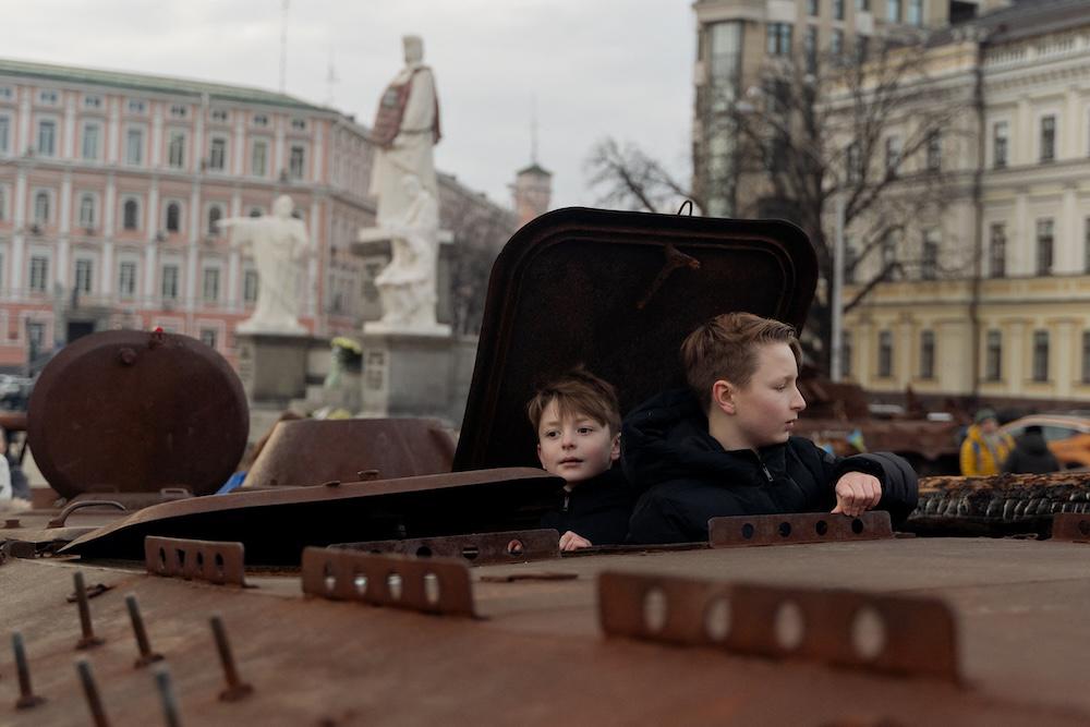 Children climb on a destroyed Russian personnel carrier at an open-air exhibition on Mykhailivska Square in Kyiv on Jan. 8, 2025. (AFP)
