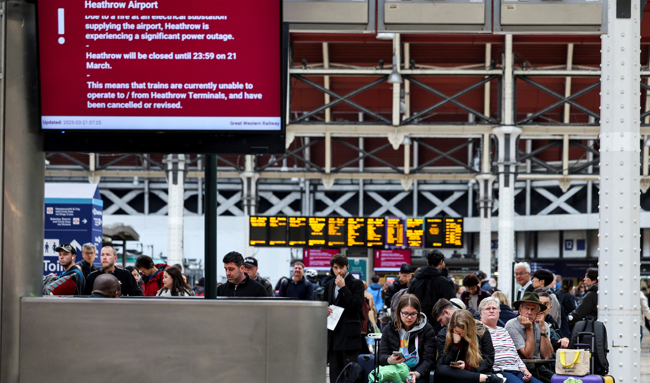 People wait at the Paddington railway station, after a fire at a nearby electrical substation wiped out power at the Heathrow International Airport, in London, Britain on March 21, 2025. (REUTERS)