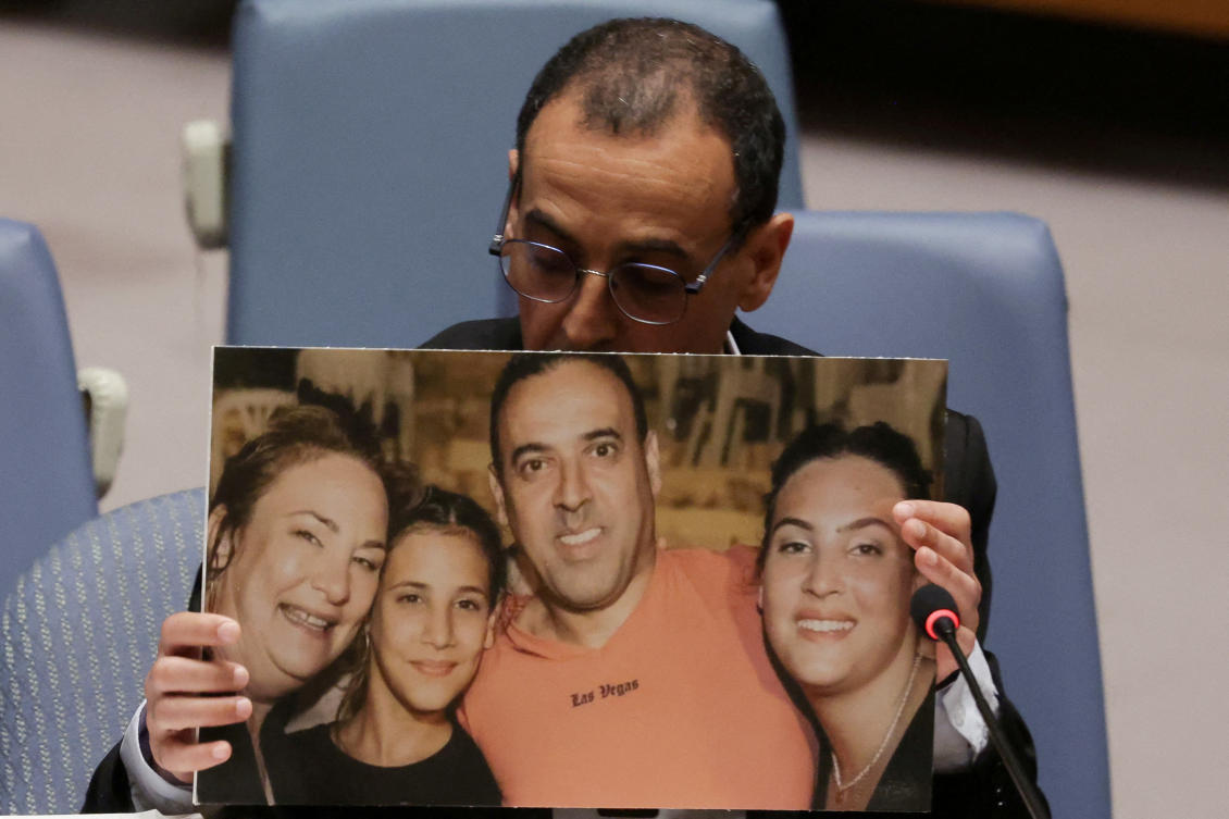 Eli Sharabi, a former Israeli hostage released by Hamas in Gaza last month, holds of a photograph of his wife and two daughters killed by Hamas, as he addresses a meeting of the UN Security Council at the UN headquarters in New York, Mar. 20, 2025. (Reuters)
