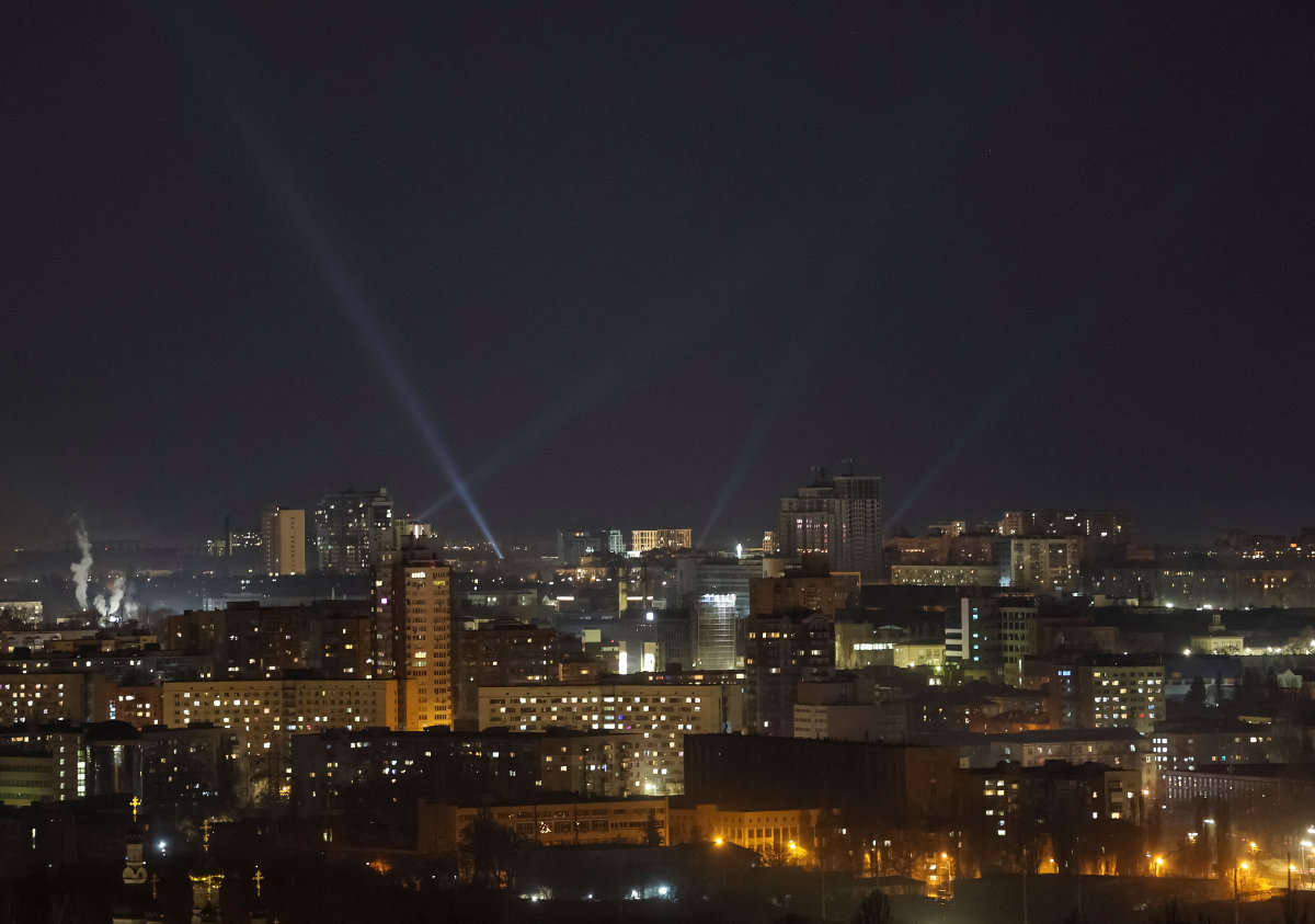 Ukrainian service personnel use searchlights as they search for drones in the sky over Kyiv on March 21, 2025, during a Russian drone strike. (Reuters)
