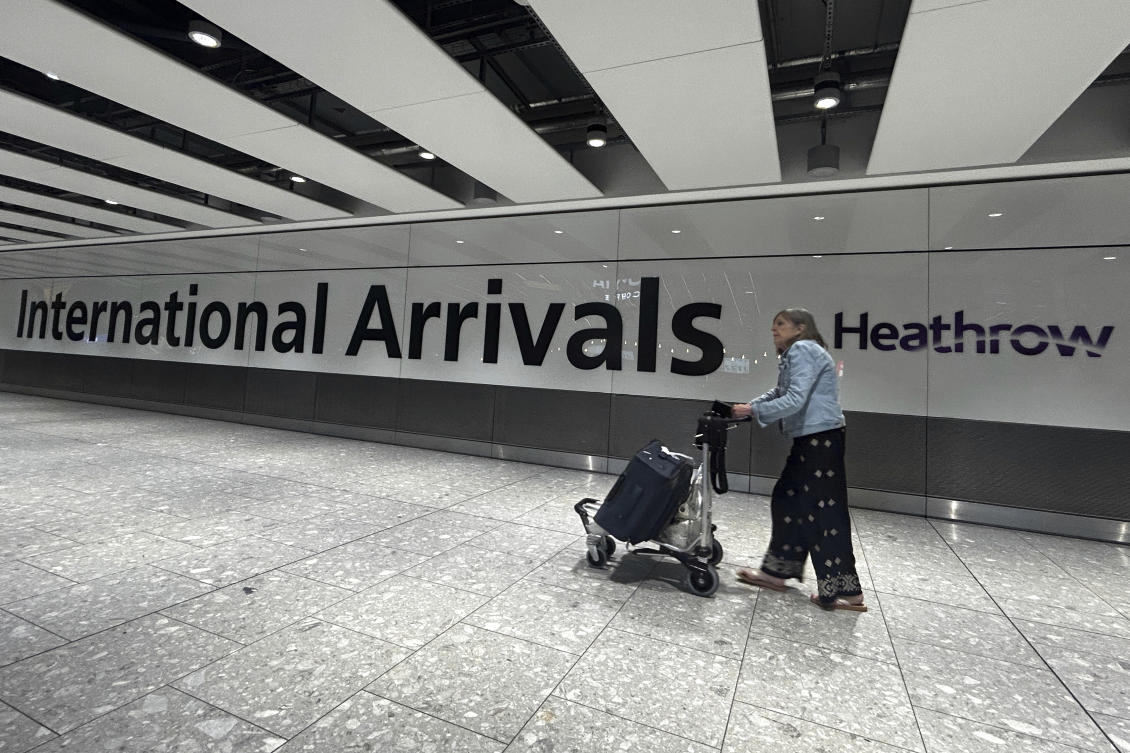 A traveller arrives at Terminal 5 as Heathrow Airport slowly resumes flights after a fire cut power to Europe's busiest airport in London, Saturday, March 22, 2025.(AP)
