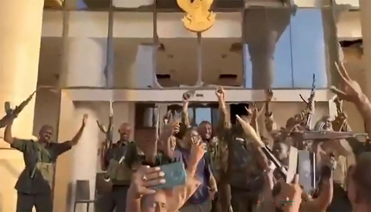 This image grab from a UGC video posted on March 21, 2025 shows Sudanese soldiers celebrating after retaking the presidential palace in Khartoum from paramilitaries. (AFP)