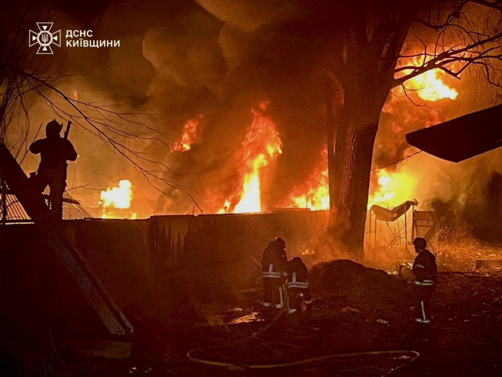 Firefighters work to extinguish a fire at a site of a Russian airstrike, amid Russia’s attack on Ukraine, in a location given as Kyiv, Ukraine in this handout picture released on March 23, 2025.