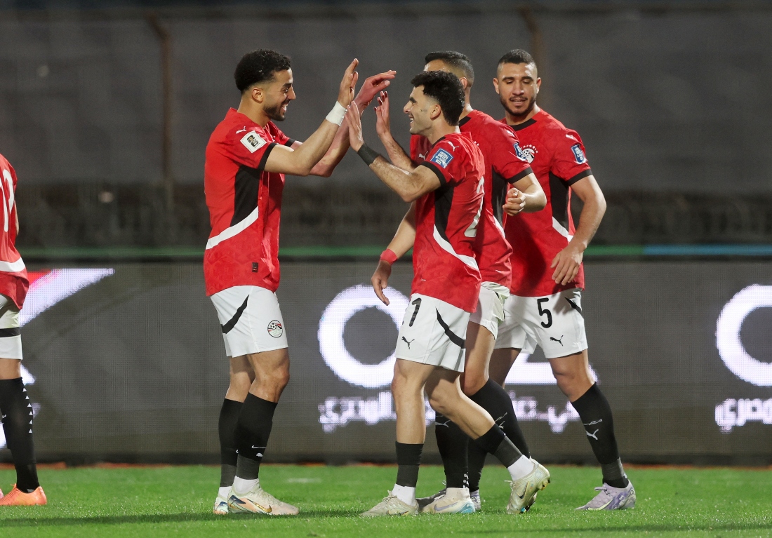 Egypt’s Zizo (right) celebrates scoring their first goal with Mohamed Abdelmonem at the African World Cup 2026 qualifiers between Egypt and Sierra Leone at Cairo International Stadium on Tuesday. (Reuters)
