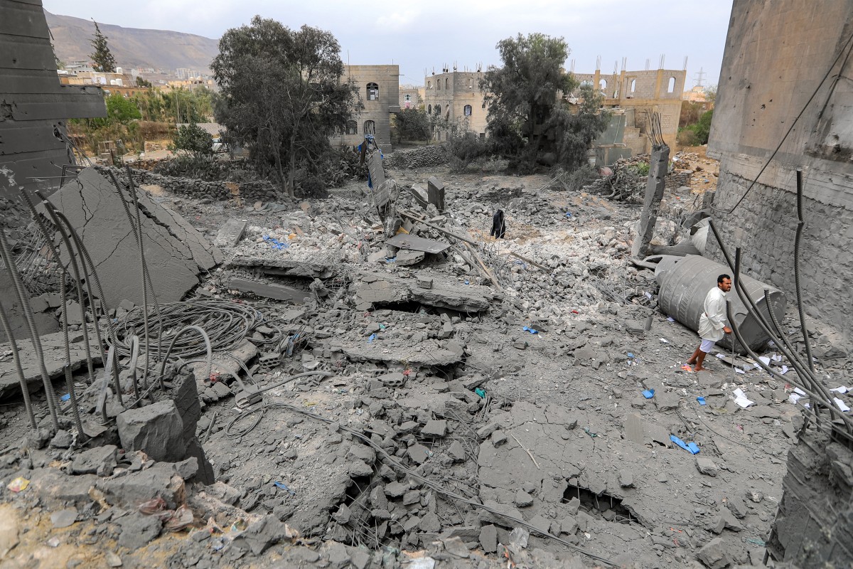 A man stands amidst the rubble of a collapsed building at the site of a reported US air strike on Yemen's Huthi-held capital Sanaa on March 24, 2025.(AFP)