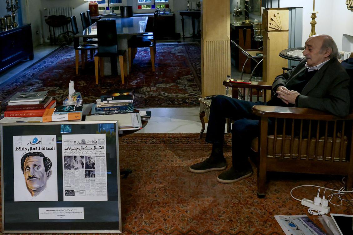 Lebanese Druze leader Walid Jumblatt sits next to a framed An-Nahar newspaper front page covering his father’s assassination in 1977, at his residence in Beirut on March 26, 2025. (AFP)