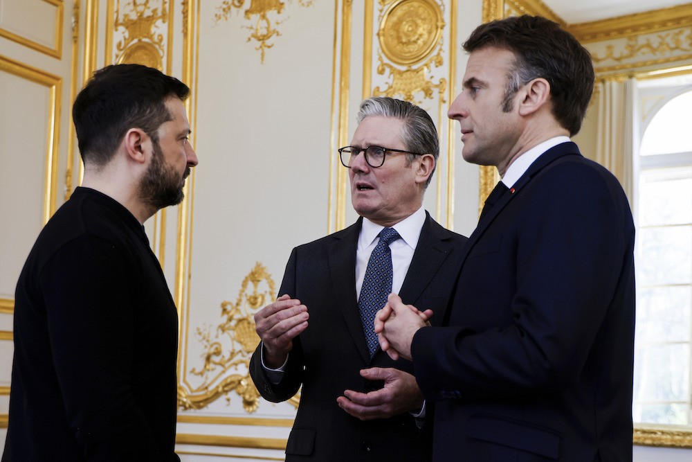 Ukraine’s President Volodymyr Zelensky, left, French President Emmanuel Macron, right, and Britain’s Prime Minister Keir Starmer speak during a trilateral meeting on the sidelines of a summit for “coalition of the willing” at the Elysee Palace, Thursday, March 27, 2025. (AP)