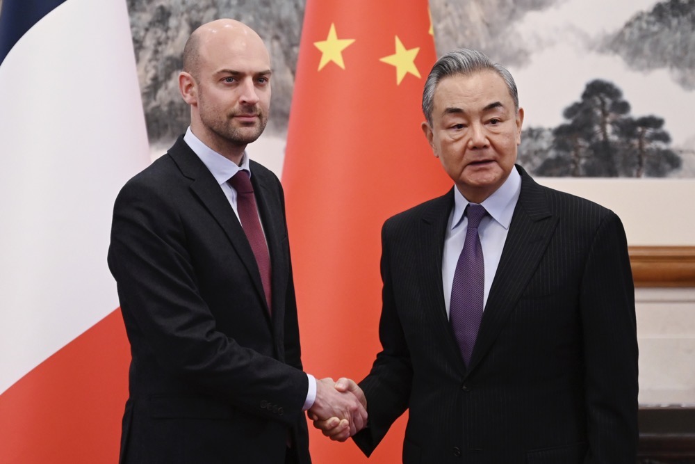 French Foreign Minister Jean-Noel Barrot shakes hands with China’s Foreign Minister Wang Yi in Beijing on Thursday. (AP)