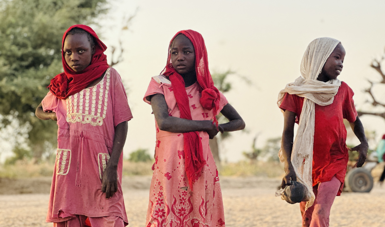 Displaced Sudanese girls, who fled the Zamzam camp, look on as they gather near the town of Tawila in North Darfur on February 14, 2025. (AFP/File)