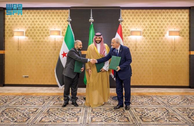 Syrian Defense Minister Murhaf Abu Qasra and Lebanese Defense Minister Michel Menassa (right) shake hands as they signed an agreement on border demarcation, facilitated by Saudi Defense Minister Prince Khalid bin Salman (center), in Jeddah, Saudi Arabia, on March 27, 2025. (SPA)