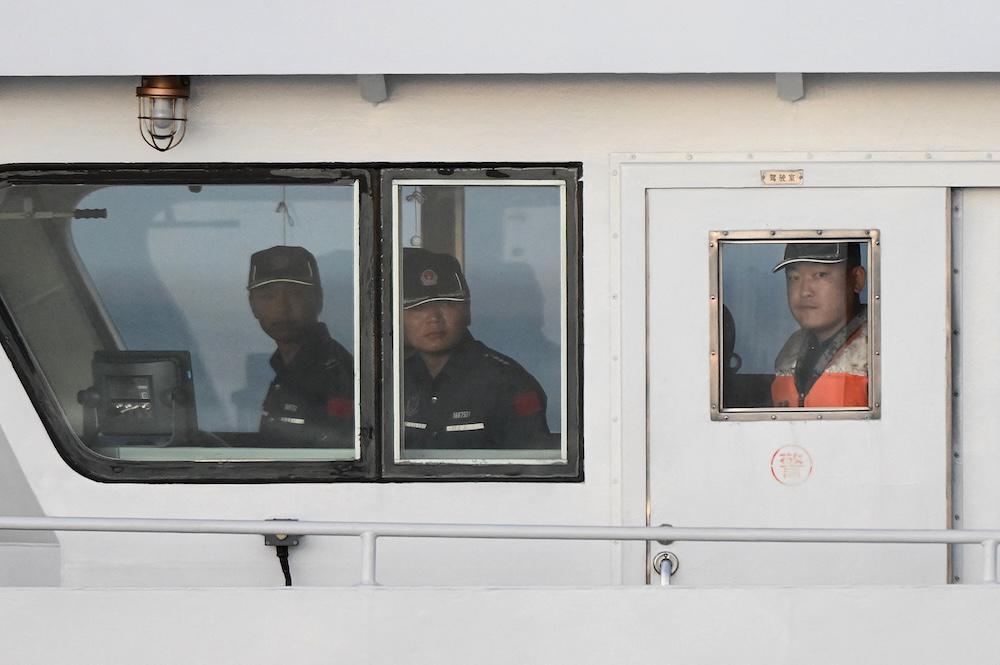 Above, Chinese coast guard personnel onboard their vessel in the disputed South China Sea March 5, 2024. (AFP)