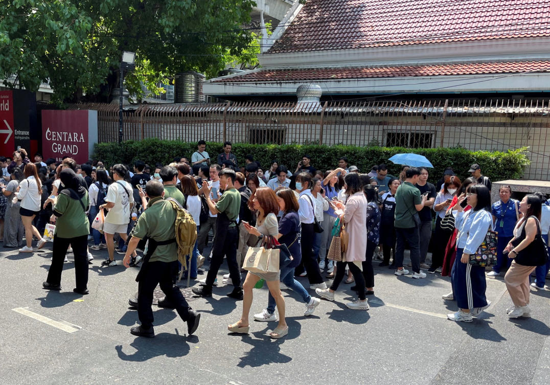 People gather on the street, after the tremors from a strong earthquake that struck central Myanmar on Friday hit Bangkok, in Bangkok, Mar. 28, 2025. (Reuters)