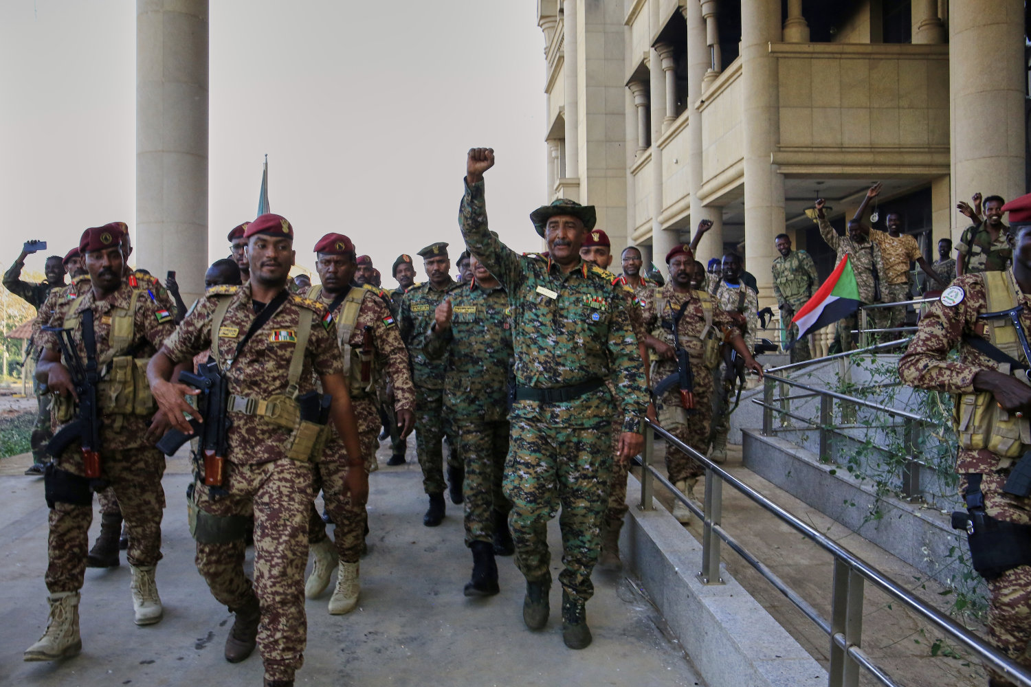 Sudan's military chief Gen. Abdel-Fattah Burhan, center, is greeted by troops as he arrives at the Republican Palace, recently recaptured from the Rapid Support Forces paramilitary group, in Khartoum on March 26, 2025. (AP Photo)