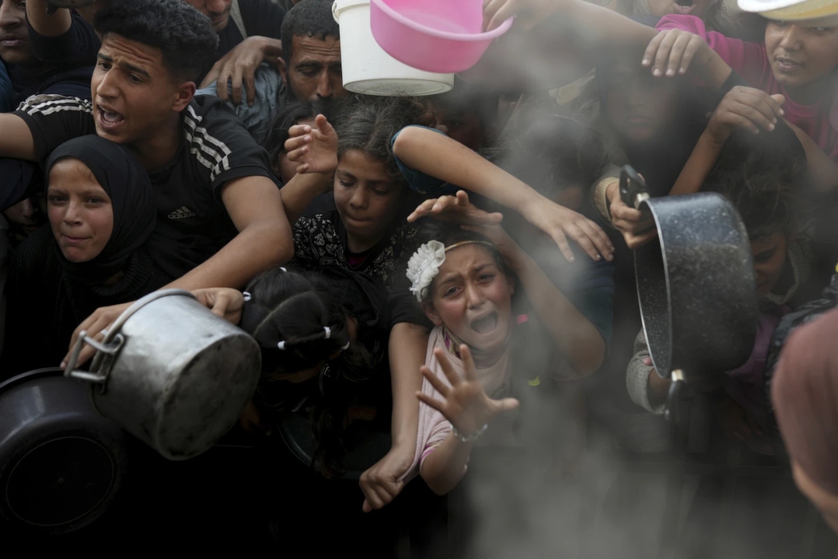 Palestinians are crowding free kitchens for prepared meals, amid fears of a catastrophic rise in hunger. (AP)