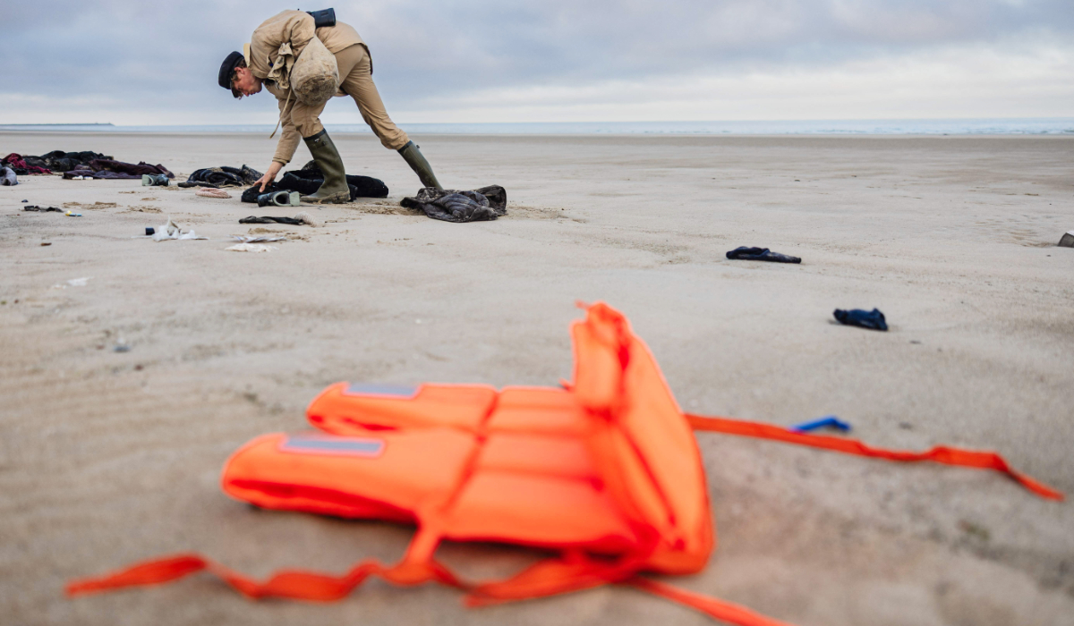 Belgian Aaron Fabrice de Kisangani, 27-years-old beachcomber searches for abandoned documents by migrants on the beach of Gravelines, north of France on March 26, 2025. (AFP)