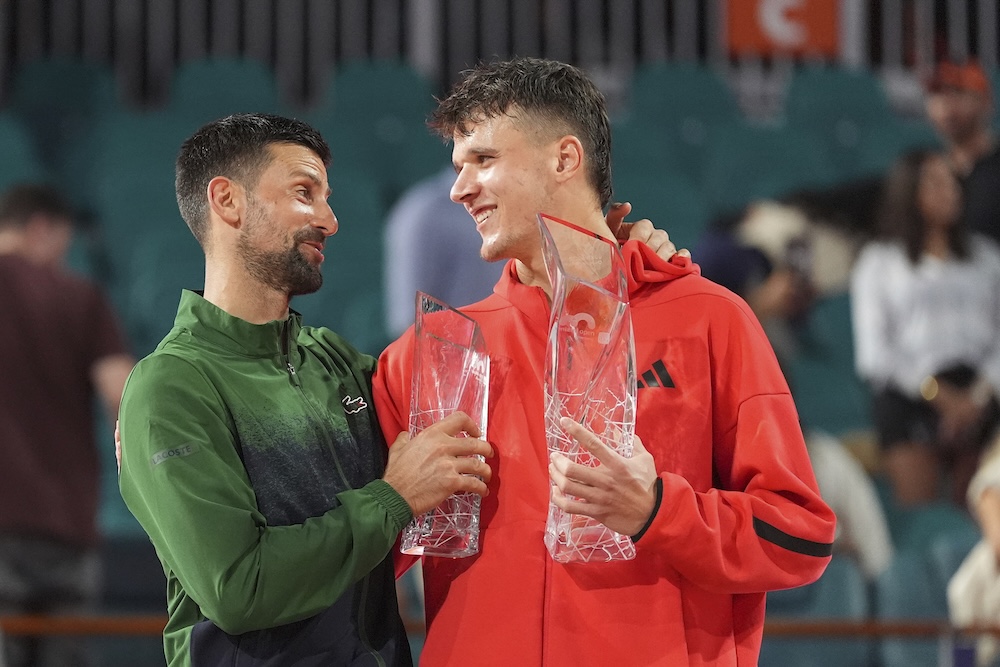 Jakub Mensik, of Czech Republic, holds the Butch Buchholz Championship Trophy after defeating Novak Djokovic, of Serbia, left, in the men’s singles final match at the Miami Open tennis tournament Sunday in Miami Gardens, Florida. (AP)