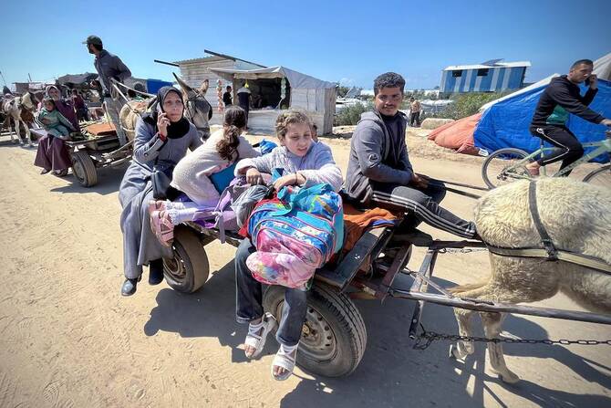 Palestinians set out with their belongings from Rafah’s Tel al-Sultan area after it was encircled by Israeli forces on March 23, 2025. (AFP)