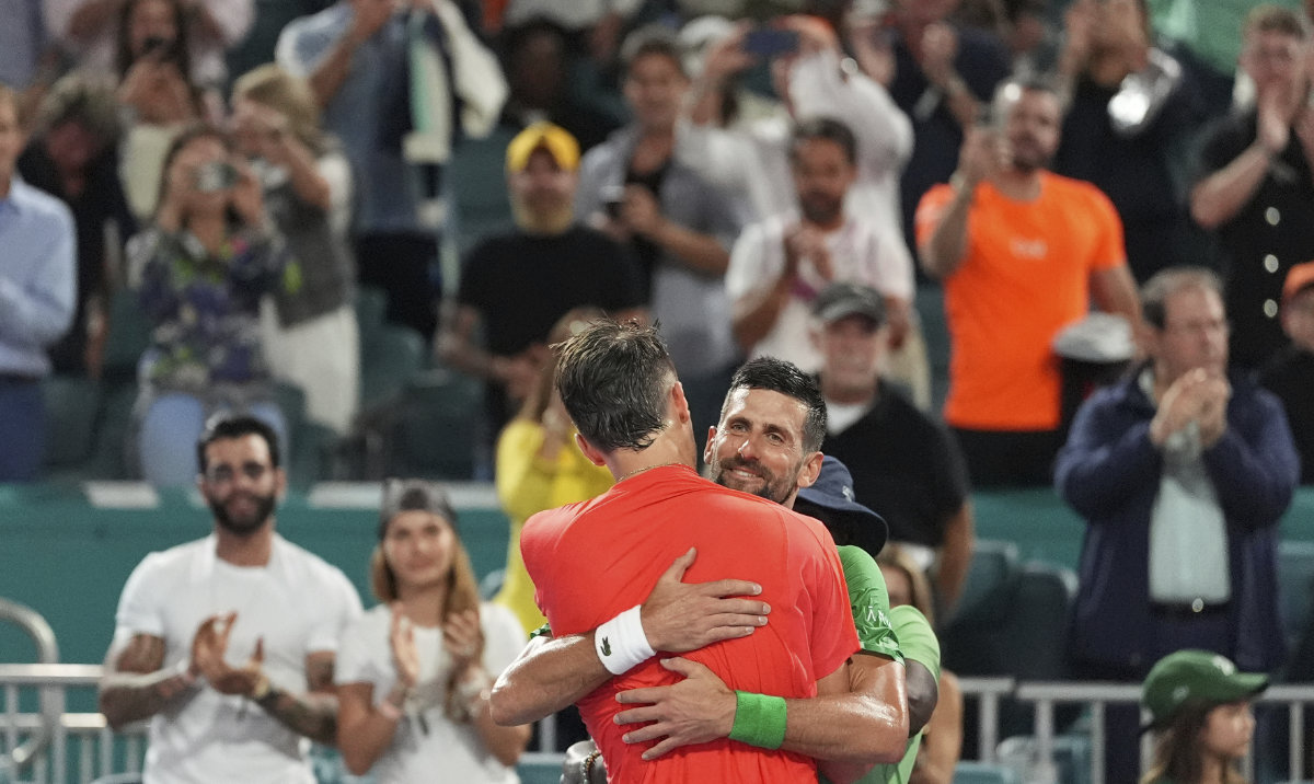 Novak Djokovic, of Serbia, center right, hugs Jakub Mensik, of Czech Republic, after Mensik won in the men's singles final match at the Miami Open tennis tournament, Sunday, March 30, 2025, in Miami Gardens, Fla. (AP)