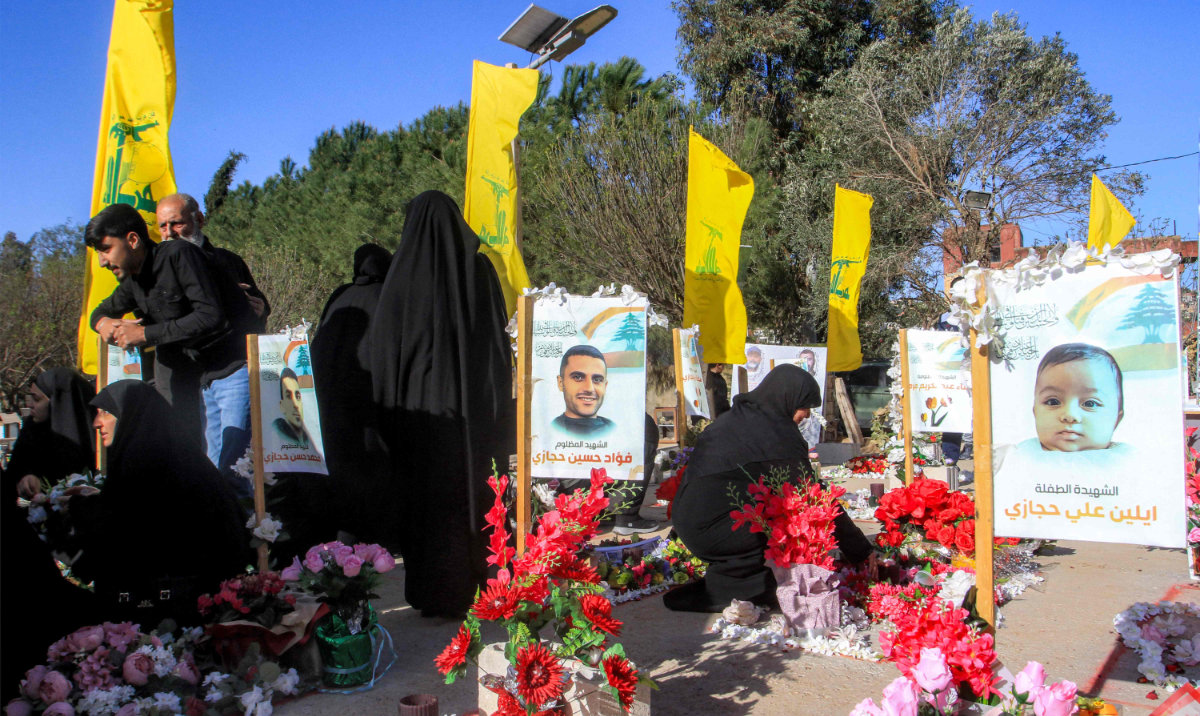 Women mourn by the graves of slain Hezbollah fighters who were killed in conflict with Israel, at a cemetery in Aitaroun near the border with Israel in southern Lebanon on March 31, 2025 on the first day of the Muslim holiday of Eid Al-Fitr at the end of the holy month of Ramadan. (AFP)