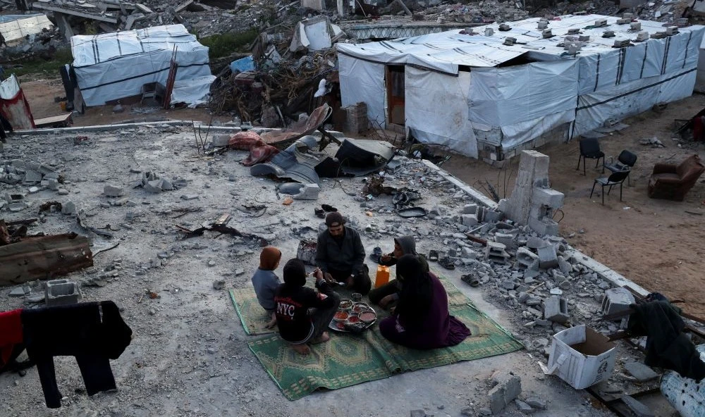 A Palestinian family partakes in an Iftar meal during Ramadan, Jabalia refugee camp, Gaza, Mar. 2, 2025. (Reuters)