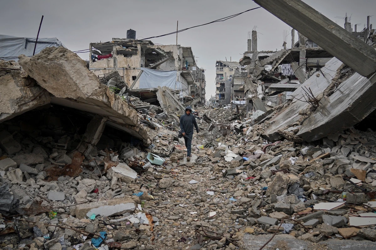A boy walks down a street covered by the rubble of destroyed homes and buildings in Beit Lahiya, northern Gaza. (AP)