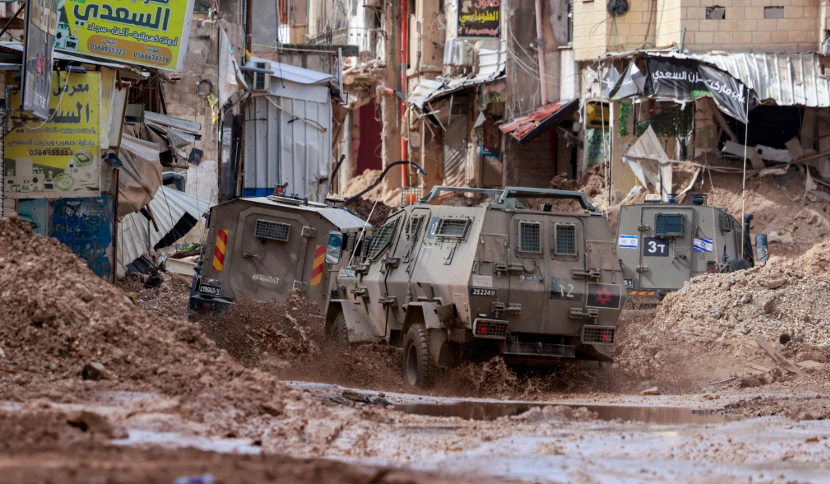 Israeli armoured vehicles drive through the Jenin camp for Palestinian refugees in the occupied West Bank. (AFP)
