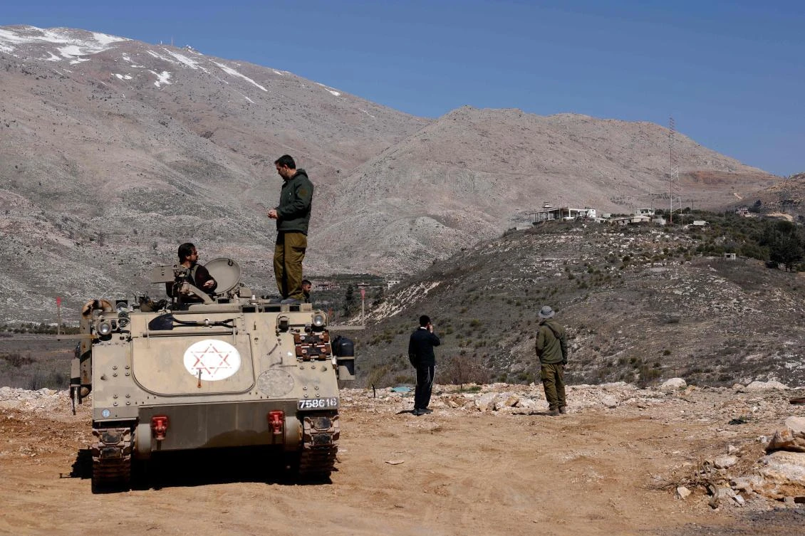 Israeli soldiers stand atop an armored personnel carrier in the buffer zone which separates Israeli and Syrian forces, near the Druze village of Majdal Shams in the Israel-annexed Golan Heights on Feb. 27, 2025. (AFP)