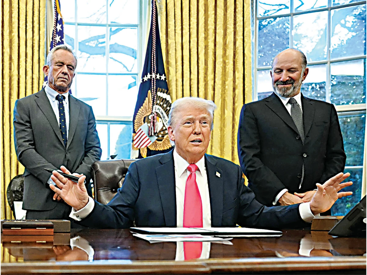 US President Donald Trump speaks to the press after signing an Executive Order, alongside US Secretary of Health and Human Services Robert F. Kennedy Jr. (L) and US Secretary of Commerce nominee Howard Lutnick (R), at the White House in Washington, DC on Feb. 25, 2025. (AFP)