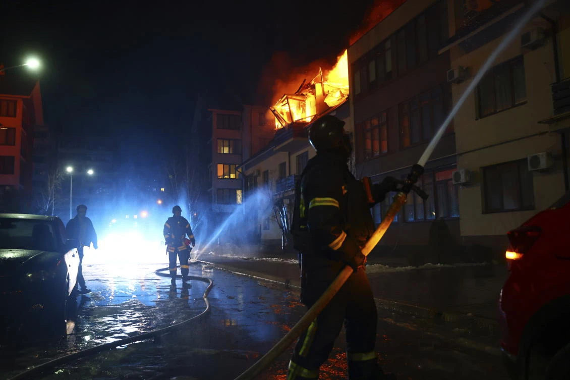 Rescue workers put out a fire from a house hit by a Russian drone strike on a residential neighborhood in Zaporizhzhia, Ukraine, Saturday, March 1, 2025. (AP)