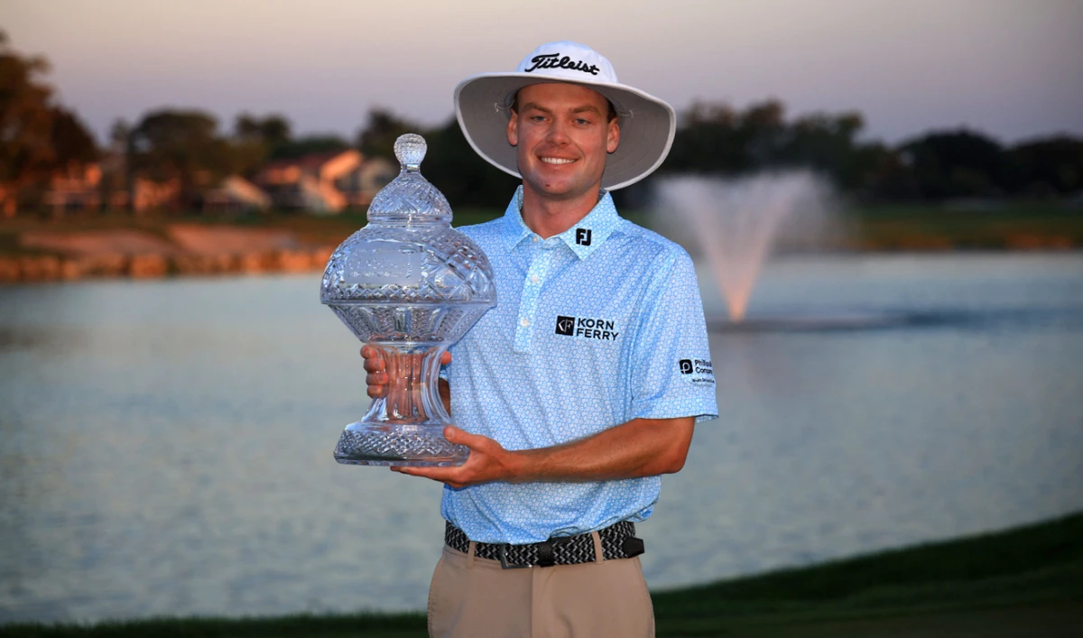 Joe Highsmith of the US with the trophy after putting in to win on the 18th green during the final round of the Cognizant Classic in The Palm Beaches 2025 at PGA National Resort And Spa on March 2, 2025 in Palm Beach Gardens, Florida. (AFP)