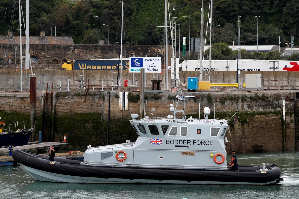 UK Border Force officials travel in a RIB with migrants picked up at sea whilst Crossing the English Channel, as they arrive at the Marina in Dover, southeast England on August 15, 2020. (AFP)