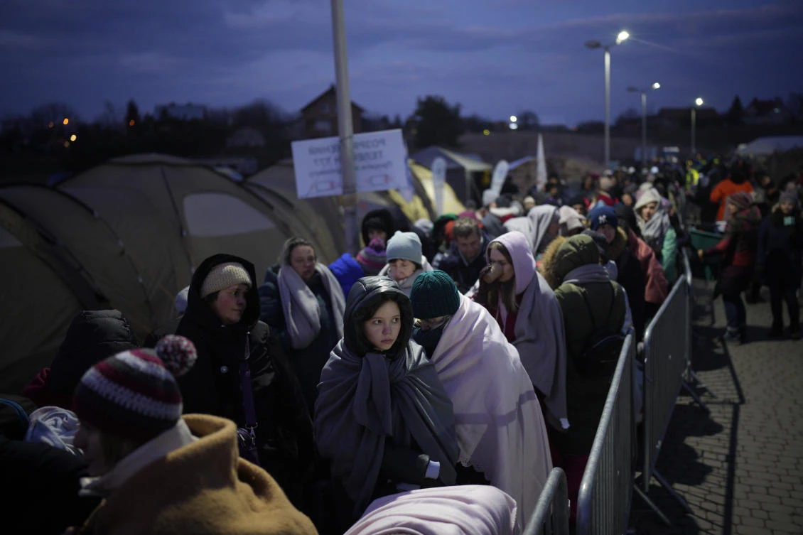 Refugees fleeing war in neighboring Ukraine queue at the Medyka border crossing, Poland, Thursday, March 10, 2022. (AP)