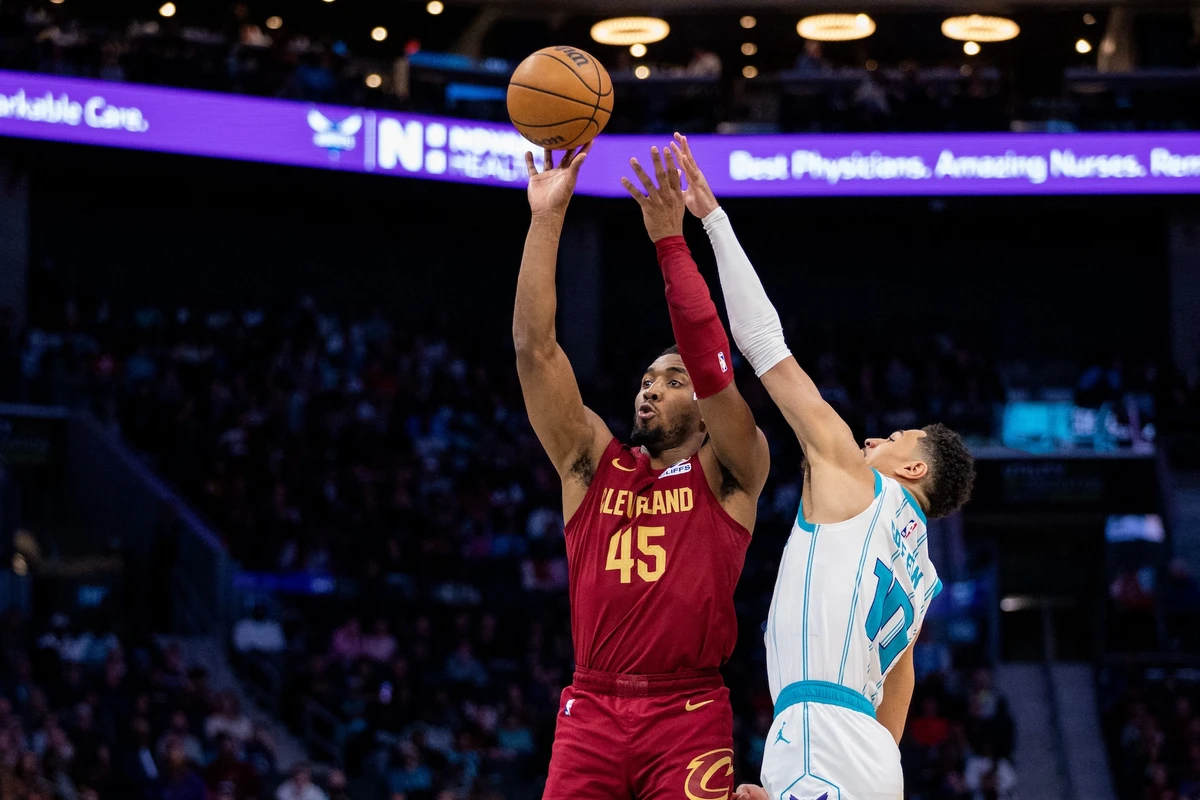 Cleveland Cavaliers guard Donovan Mitchell shoots against Charlotte Hornets guard Josh Green during the fourth quarter of an NBA game at Spectrum Center. (Scott Kinser-Imagn Images)