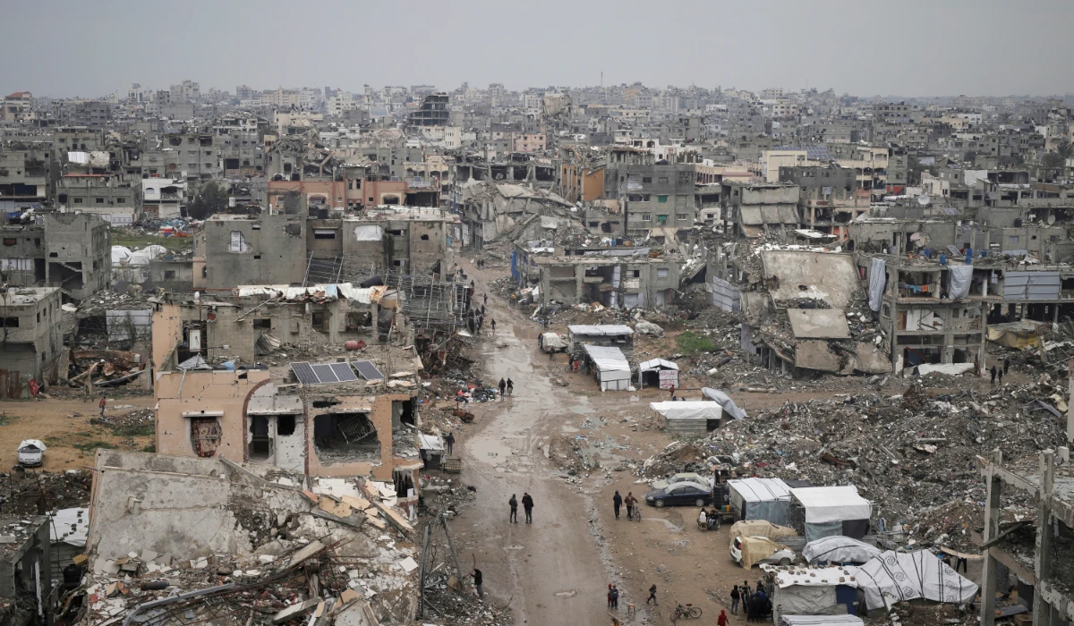 Palestinians walk surrounded by the rubble of destroyed homes and building in the Zeitoun neighborhood of Gaza City, Friday, March 7, 2025. (AP)